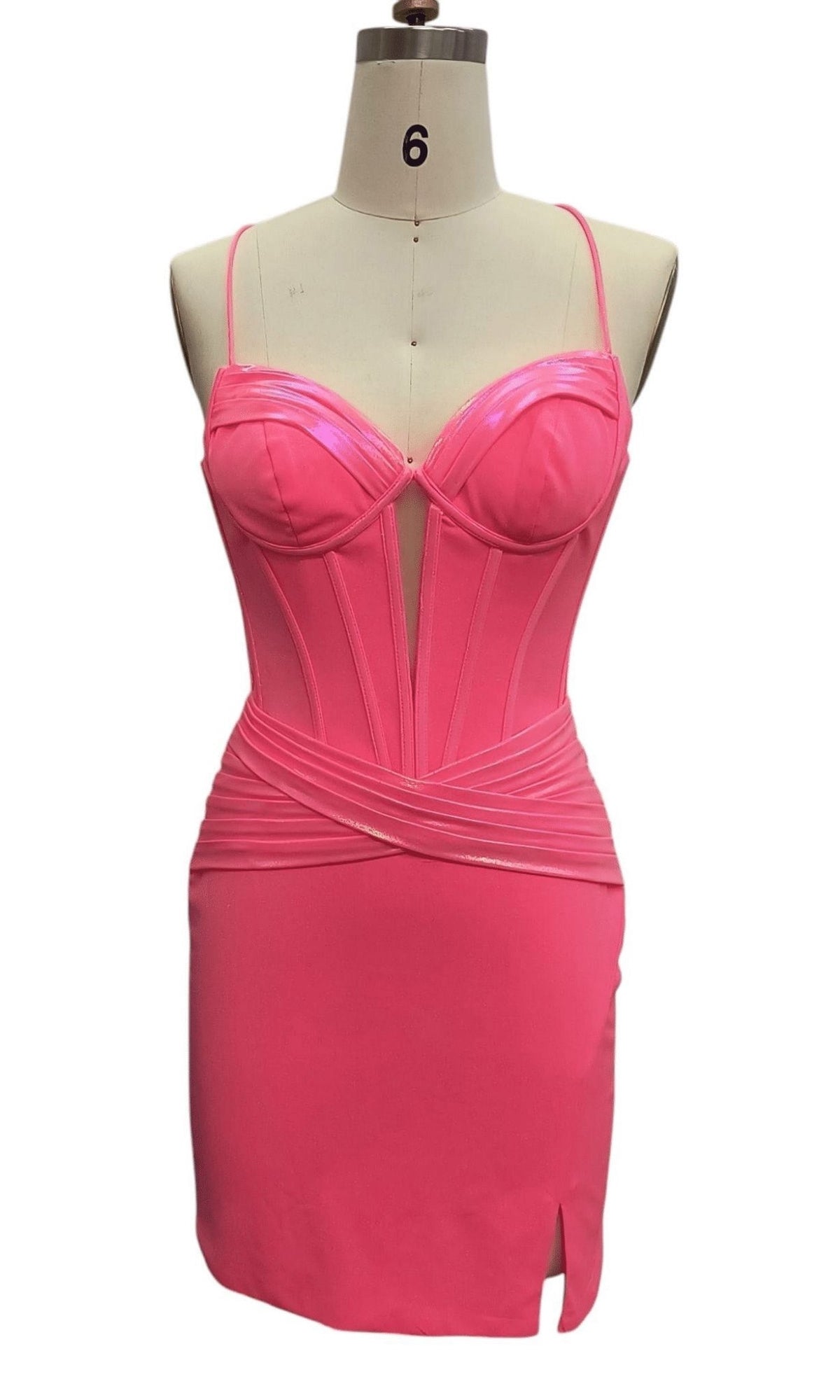 The Short Corset Hoco Dress: 12386 is a hot pink party dress featuring spaghetti straps, a structured corset bodice, and a thigh-high slit, shown on a dress form.